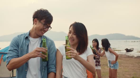 Group of Asia best friends teenagers focus on couple toast beer enjoy camping party with happy.
