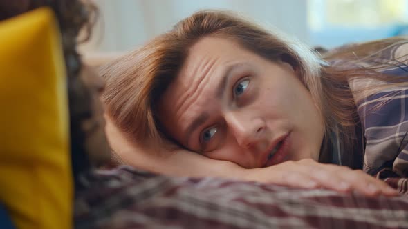 Loving Same Sex Male Couple Lying on Bed at Home Hugging Together alt