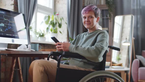 Portrait of Positive Woman on Wheelchair Working at Home alt