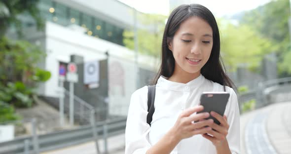 Young Woman use of smart phone in city alt
