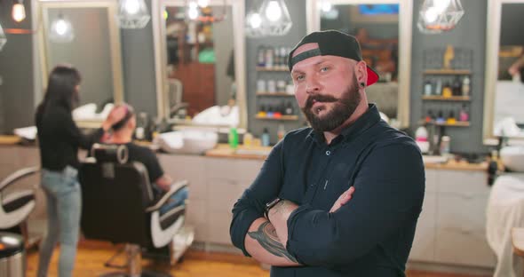 Young Bearded and Mustashed Man with Tattoed Hands with Chin Ring and Tunnel Earrings in Baseball alt