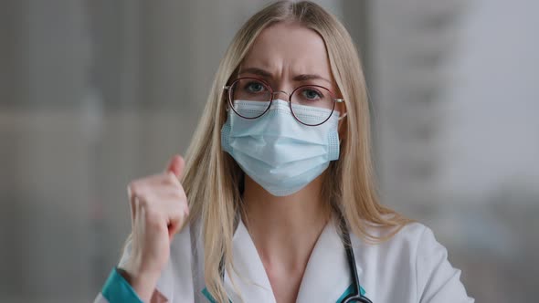 Female Doctor in Medical Mask Looking at Camera Talking Angry Show Index Finger No Negative Gesture alt