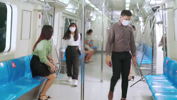 Crowd of People Wearing Face Mask on a Crowded Public Subway Train Travel alt