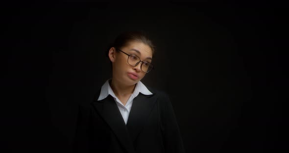 Business Woman with Glasses Shrugs Her Shoulders