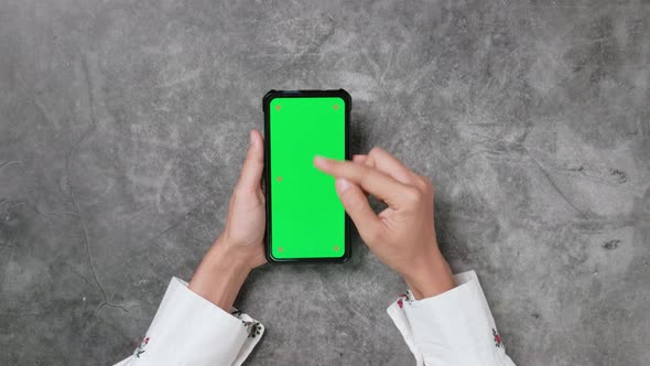 Woman hands using smartphone and hand touching, clicking, zoom in, zoom out, and swiping on desk alt