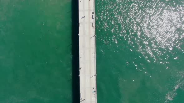 Aerial Top View of Huntington Pier, Beach and Coastline During Sunny Summer Day alt