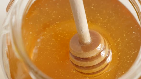 Wooden honey dipper used in jar slow-mo  1920X1080 HD footage -  Slow motion of golden sweet food su