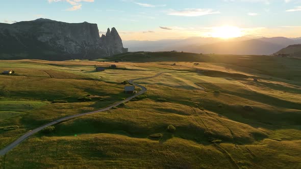 Dolomites cottages under the rugged peaks at sunrise