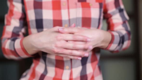 girl rubs hand cream in her fingers alt