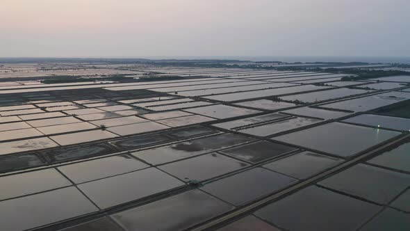 Aerial top view of natural sea salt ponds. Farm field outdoor. Material in traditional industry alt
