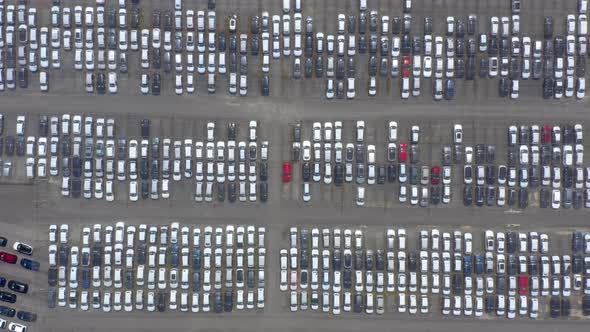 Aerial view of the parked new cars at the automotive plant.  alt