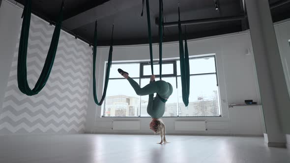 Young Beautiful Woman Practice in Aero Stretching Swing alt