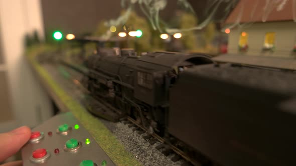 Model Steam Locomotive Passing Through Station. alt