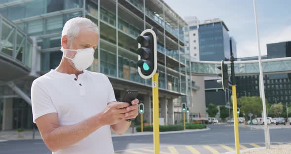 Caucasian man out and about in the street wearing on a face mask against coronavirus alt