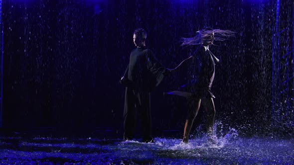 Ballroom Dancers Dancing Passionate Latin American Bachata Dance in Pouring Rain alt