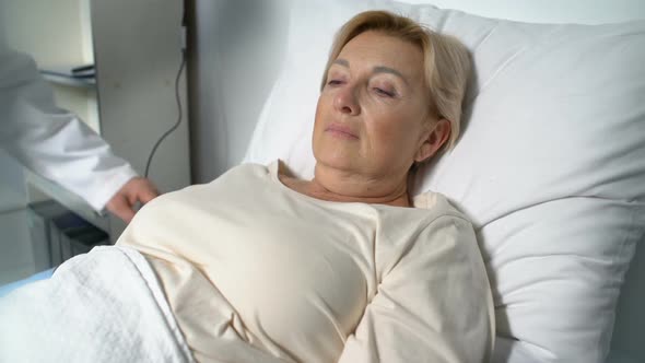 General Practitioner Hugging Female Patient Over Shoulders, Supporting, Recovery