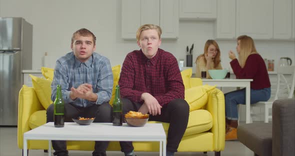 Soccer Fans Clinking Beer Bottles Celebrating Victory alt