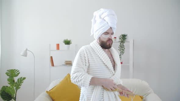 Carefree Funny Young Man Having Fun Dancing Alone at Home in a Bathrobe and a Towel on His Head alt