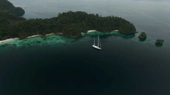 Triton Bay: Boat On Turquoise Sea And Green Tropical Trees In Kaimana Islands.  alt