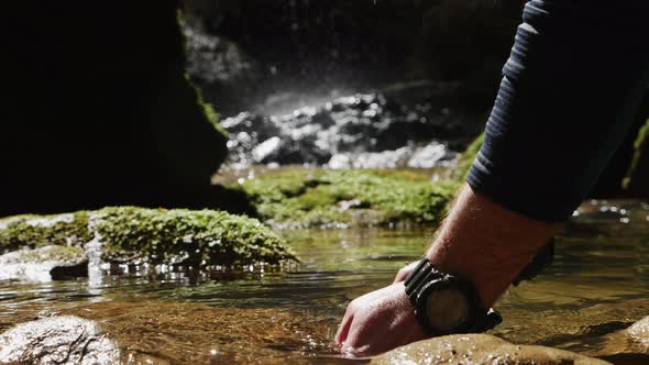 Close Up of the Hands of a Man Grabbing and Lifting Water in Pure Mountain River