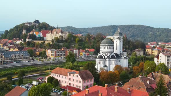 Aerial drone view of the Historic Centre of Sighisoara, Romania. Old buildings, Holy Trinity alt