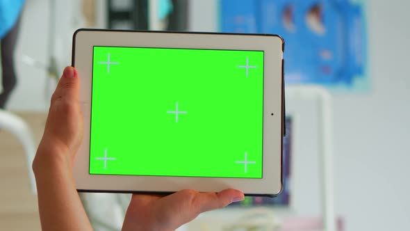 Vertical Video Close Up of Tablet with Green Screen Display Held By Dental Assistant alt