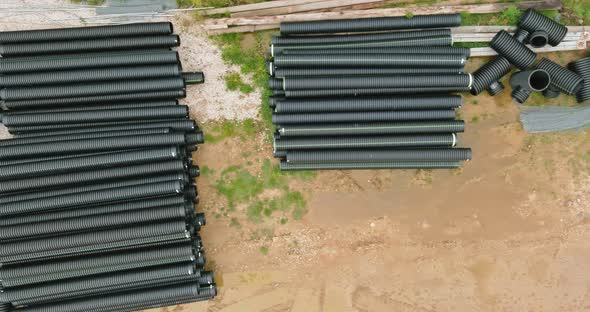 Plastic PVC Pipes Stacked in Rows at a Construction Site on Reconstruction of the City Drain System alt