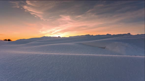 Snowdrift waves in sunset light, 4k timelapse with dolly alt