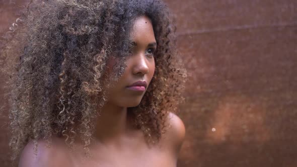 Headshot of beautiful young woman with afro hair alt