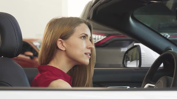 Gorgeous Woman Posing in Her New Convertible Holding Car Keys alt