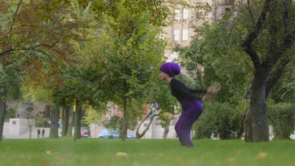 Strong Active Woman in Hijab Sporty Dancer Yoga Trainer Athlete in Park Outdoors Flying Jumping Into alt