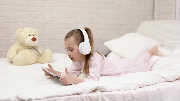 Little Child Baby Girl Listening To the Music with Headphones