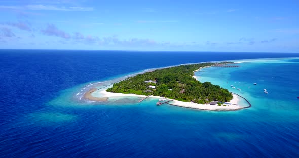 Beautiful overhead travel shot of a white sand paradise beach and blue ocean background in 4K alt