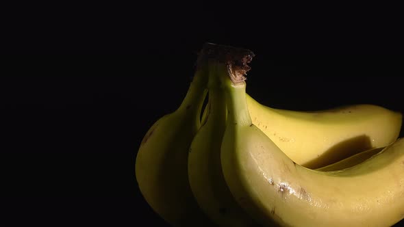 Closeup Shot of Wet Bananas Rotating on a Turntable with a Black Background