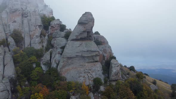 Mountains with Rocky Sculptures That are Getting Covered By Clouds