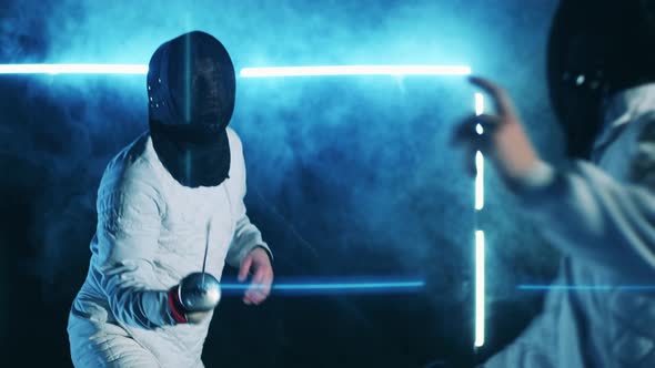Fencing Training Session of Two Athletes in Protection Wear alt