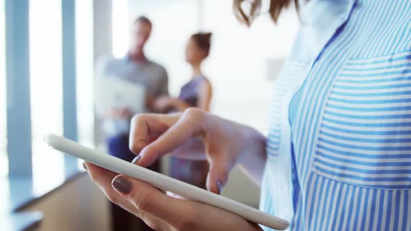 Female executive using digital tablet alt