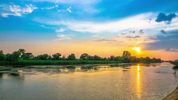 Beautiful Sunset Cloudy Sky over the River with Rain alt