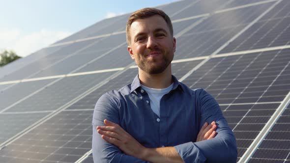 Happy Caucasian Engineer in Helmet Smiling at Camera at Solar Power Station Outside alt