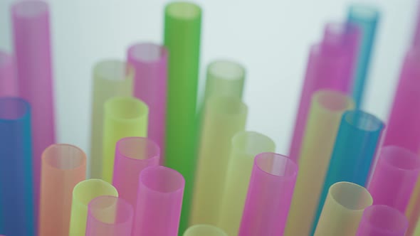 Cocktail Multicolored Plastic Tubes on a Dark Background Camera Motion alt