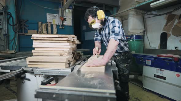 A Man Works with a Planer alt
