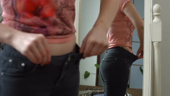 Woman Showing Her Progress After Weight Loss alt