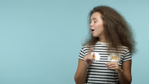 Slow Motion of Silly Cute Girl in Tshirt Turn Head Looking and Pointing Left at Copy Space with your alt