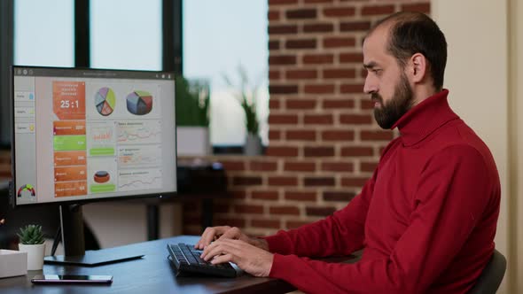 Male Employee Working on Computer to Develop Sales Profit alt