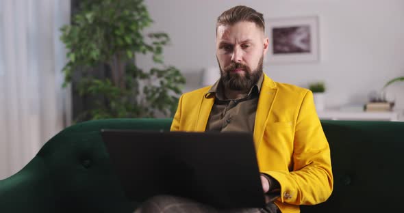 Businessman on Couch with Laptop