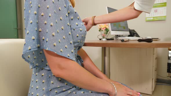 Neurologist Examines Female Patient with Needle to Test Sensibility alt