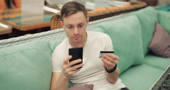 Man Writes Number of Credit Card Into Smartphone Online Banking