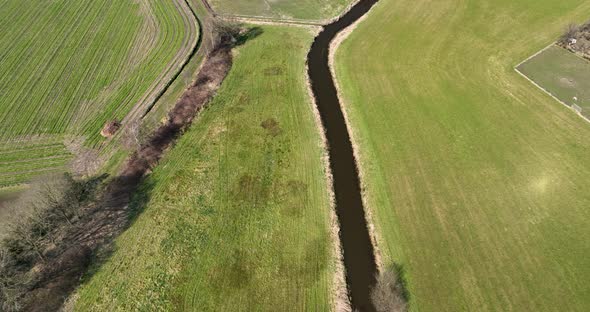 Aerial view of a small river crossing the countryside, Overijssel, Netherlands. alt