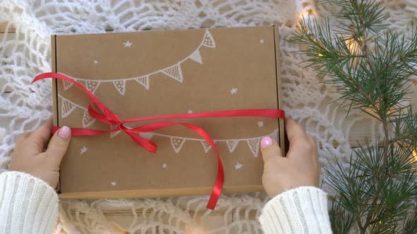 Female Hands Unpack New Year's Gift - Gingerbread Cookies in a Cardboard Box
