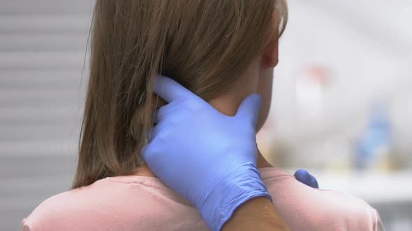 Manual Therapist Examination of Trigger Zone Female Patients Neck, Back View